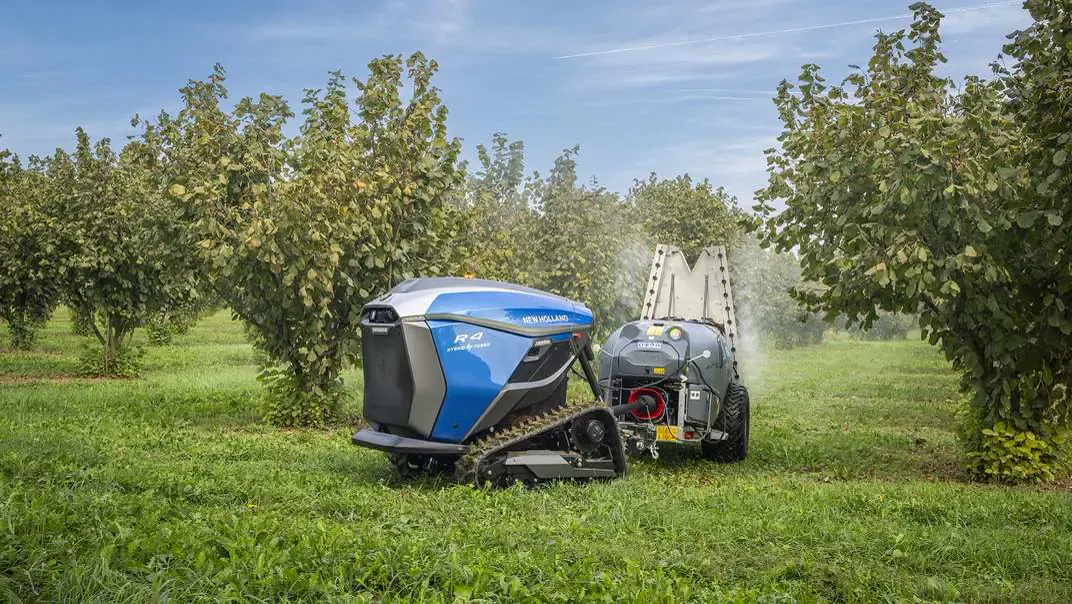 New Holland R4 Hybrid Power spraying in an orchard