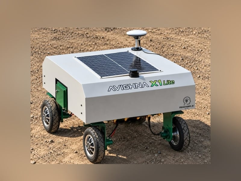 Pragyanik AI Avighna X1 Lite, a small four-wheeled robot with a solar panel on top, on bare soil